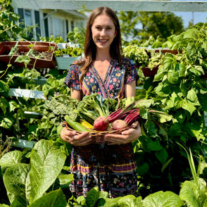 Beets and Bees catering, woman holding basket of vegetables